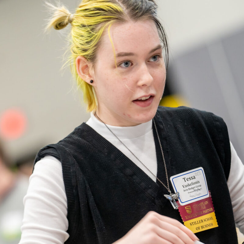 a representative from avis budget group talks to students at a career fair event