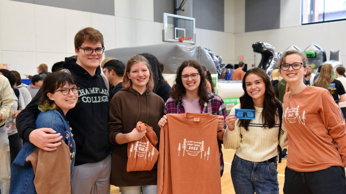 A group of students holding up shirts at Camp Champ Spirit Week 2022 hosted by CHAMP