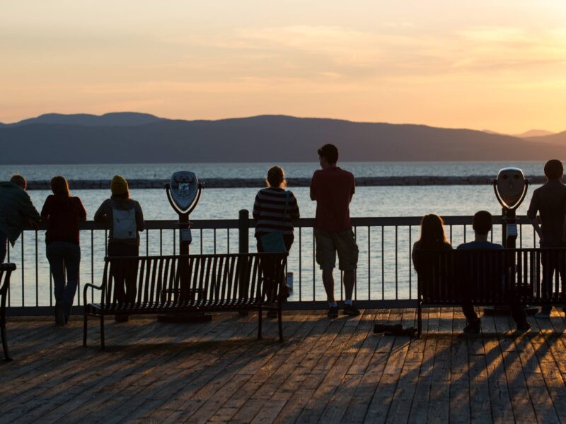 people standing on a pier at the waterfront