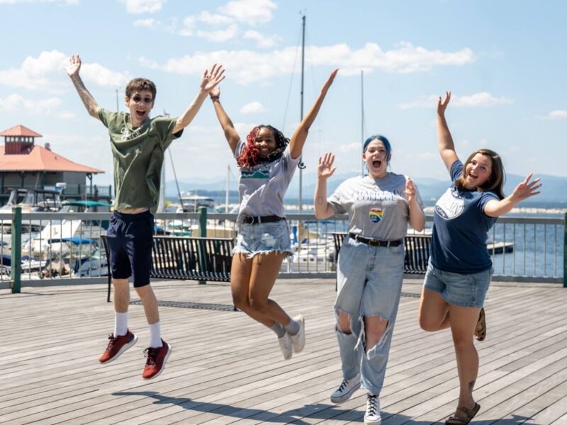 Students jumping on the pier at the waterfront