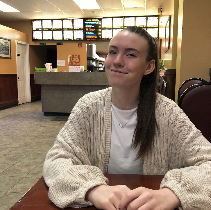 Alex McKenna sitting at a table