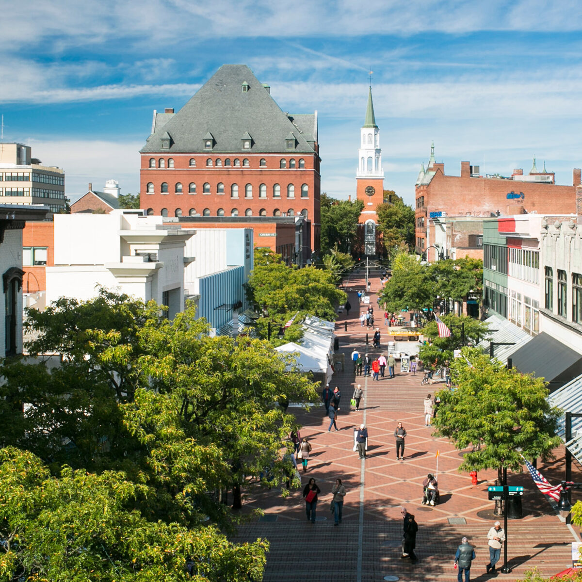 A high-angle view of church street in Burlington with people walking down the cobblestone